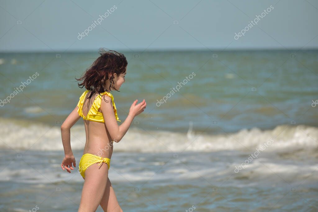 Naked girl running in water